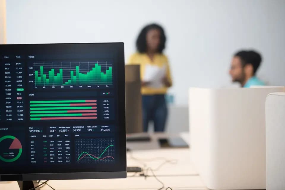 A team working in front of screens carrying live figures