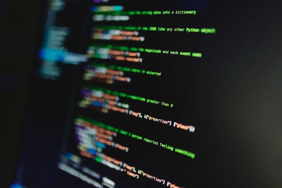 Lines of code filling a monitor, thrown out of focus