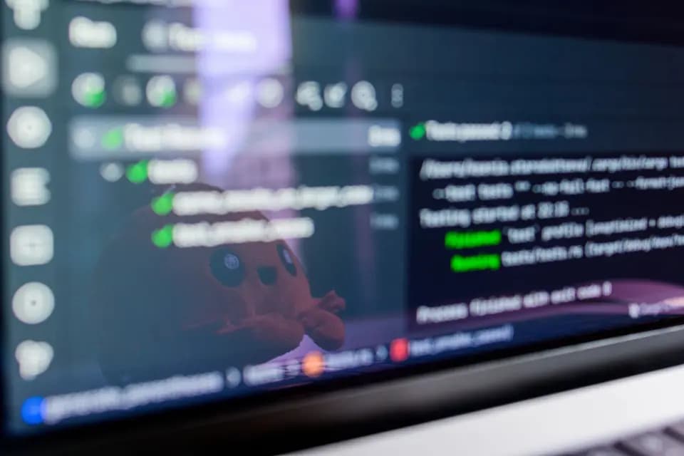 Code reflected in a laptop screen in a darkened room