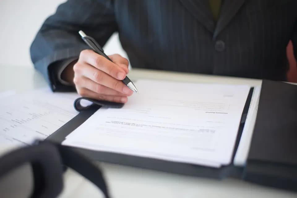 A document being signed at a desk