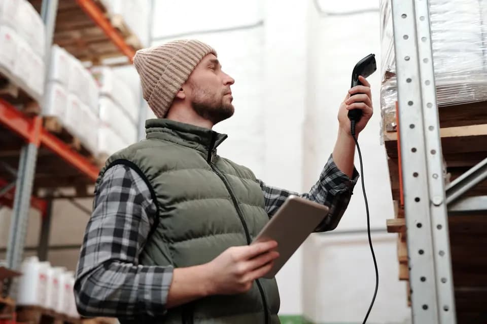 Warehouse staff scanning received goods against a handheld terminal
