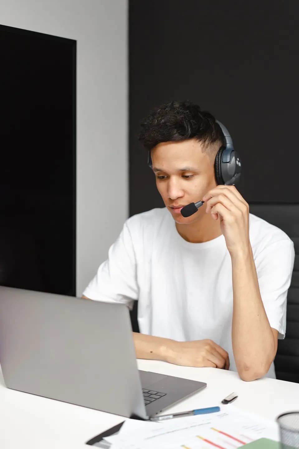 A support agent taking a call at a laptop