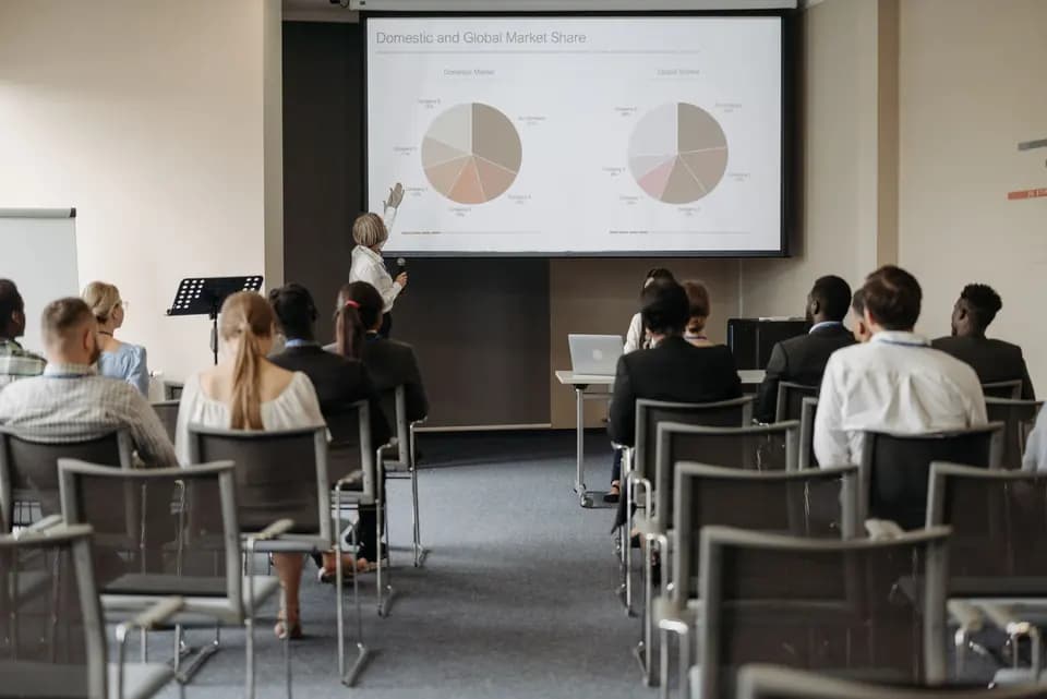 An audience watching a presentation at a work event