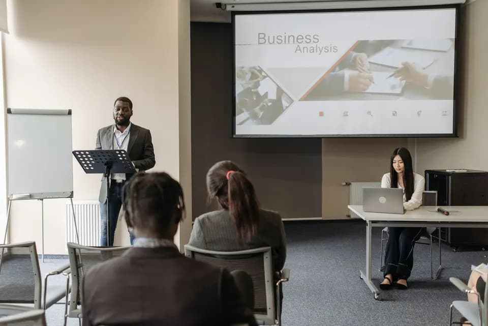 A speaker presenting to an audience at a work seminar